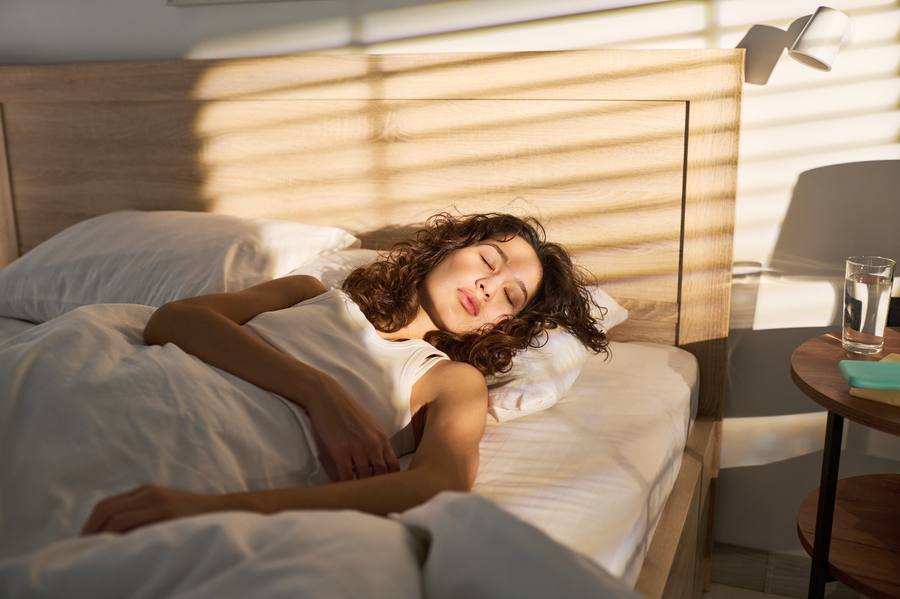 Well-rested woman over 40 supporting wellness naturally
